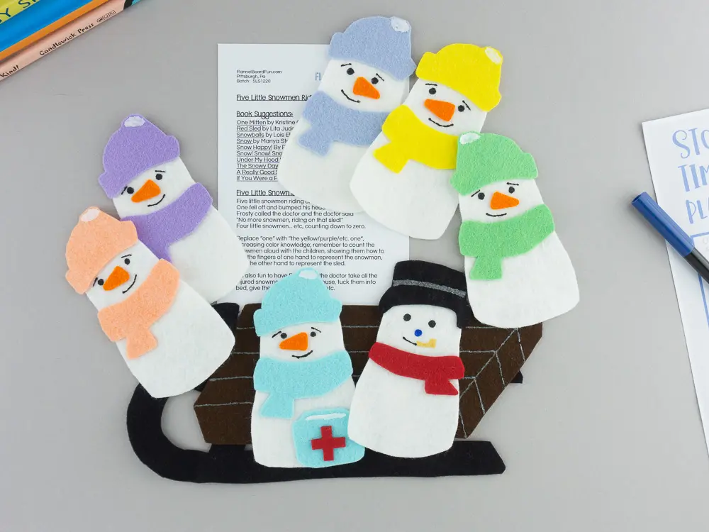 Felt snowmen and sled with song card